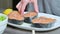 Close-up of the hands of a cook girl who prepares fresh fish salmon trout watering with lemon juice. Squeezes lemons