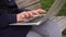 Close up hands of copywriter typing on laptop keyboard outside in slow motion.