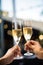 close up on hands of a couple holding glasses of champagne making a toast. celebration with champagne with blurred background boke