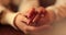 Close-up of the hands of a couple in love sitting at a table in a cafe