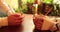 Close-up of the hands of a couple in love sitting at a table in a cafe