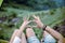 Close up of hands couple lover showing heart shape in tent together,Enjoying camping concept