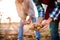 Close up of hands of couple planting potatoes into ground