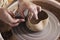 Close-up of the hands of a craftsman ceramist working with her p