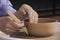 Close-up of the hands of a craftsman ceramist working with his p