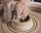 Close-up of hands of a craftsworker ceramist molding a vase in h