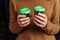 Close-up of hands with cups of coffee. Girl bought takeaway coffee. Beautiful  fragrant  freshly brewed cappuccino with a