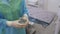 Close-up hands of doctor pours disinfectant into glass jar held by nurse