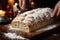 Close-up of hands dusting a Christmas stollen - stock photography concepts