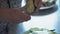 Close-up, the Hands of an Elderly Woman with the Help of a Knife Slice Thin Stakes Cucumber