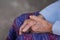 Close-up of hands elderly woman`s joined together. Focus on hands wrinkled skin. Space for text. Concept of aged people