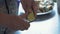 Close-up, Hands of an Elderly Woman Slice a Cucumber