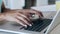 Close-up of hands of elegant young business woman working with her laptop in the office.