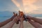 Close up of hands of friends clanging bottles of beer together and celebrating on holiday in party at the beach or sea in summer