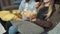 Close-up of the hands of friends taking popcorn from a large transparent bowl while watching a movie or series on television