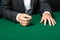 Close up of hands of gambler sitting at the poker table