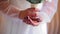 Close up of the hands of a girl holding a bouquet of flowers