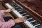 Close-up of the hands of a girl playing the piano. Teenage girl learns to play the piano