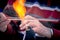 Close-up of the hands of a glassblower working on a glass object.