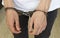Close-up of hands in handcuffs, the prisoner guy the arrested man handcuffed hands
