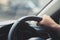 Close up of hands hold steering wheel young man driving a ca