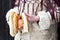 Close up of hands holding apple and pretzel of a child dressed in traditional Romanian wear