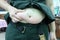 Close up, hands are holding the belly Older Asian women are obese with black moles on the skin, stomach, belly, big fat.