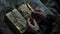 Close-up of hands holding a cross over an ancient book in dim light. a moment of faith and contemplation captured