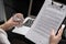 Close-up of hands holding glass of water and getting acquainted with the contract