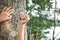 Close up hands holding knife on big tree