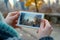 close up of hands holding photo with picture of city on city background, travel concept