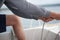 Close up of hands holding a rope, sheet on a sailboat