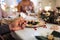 Close-up of hands holding together at the table at Christmas, praying concept.