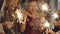 Close-up of hands holding and waving sparklers. Portraits of young caucasian and asian girl at birthday party. Happy
