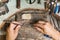 Close-up of the hands of a jeweler making repairs to a gold bracelet