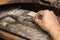 Close-up of the hands of a jeweler making repairs to a gold bracelet