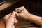 Close-up of the hands of a jeweler making repairs to a gold bracelet