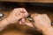 Close-up of the hands of a jeweler making repairs to a gold bracelet