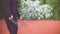 Close-up of hands an jumping women on the jump rope. Outdoor sports. Girl jumping on a skipping rope on on athletic field Flower