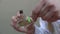 Close-up of the hands of a lab technician mixing liquid on a glass plate and the ongoing reaction