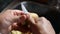 Close up of hands of a latin indigenous woman who is peeling potatoes in her kitchen sink