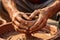 Close-up of hands making clay pots