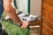 Close-up of the hands of a man carrying a tray of fried fish. Selective focus macro shot with shallow DOF