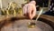 Close up hands of a man cooking turkish coffee on hot sand