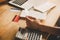 Close up hands of man holding credit card and calculating monthly invoices