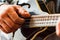 Close up hands of man playing 8-string mandolin