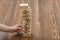 Close-up hands of man pulls out wooden bricks