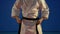 Close up hands of a man putting on the black belt on his white karate kimono in slow motion