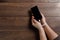 Close-up, hands of a man tied with a cord to the smartphone. The concept depends on technology, phone, social networks, a blogger