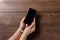 Close-up, hands of a man tied with a cord to the smartphone. The concept depends on technology, phone, social networks, a blogger